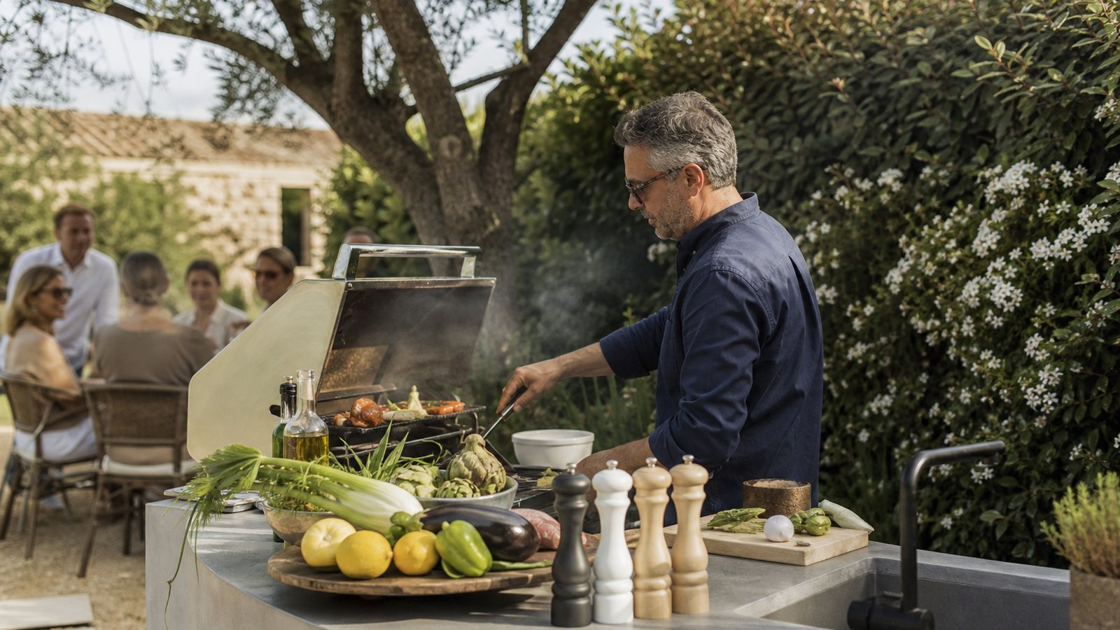 Cuisine extérieure haut de gamme conçue sur mesure, plancha et plan de travail dans un jardin
